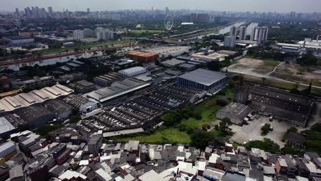 drone shot rotating over the jaguare slum, towards a industrial area in sao paulo, brazil