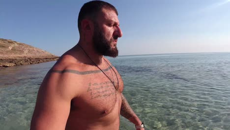 man walking along the mediterranean coast