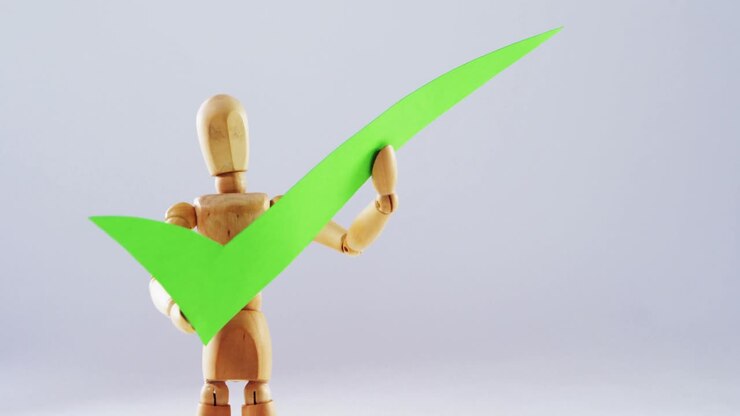 Figurine holding correct sign