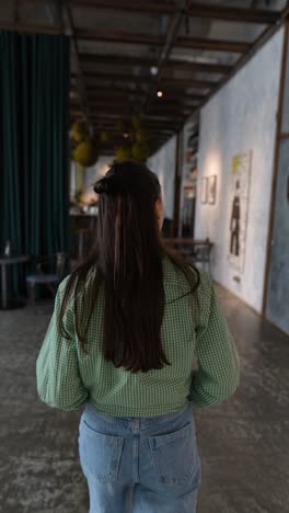 woman walking in a cafe