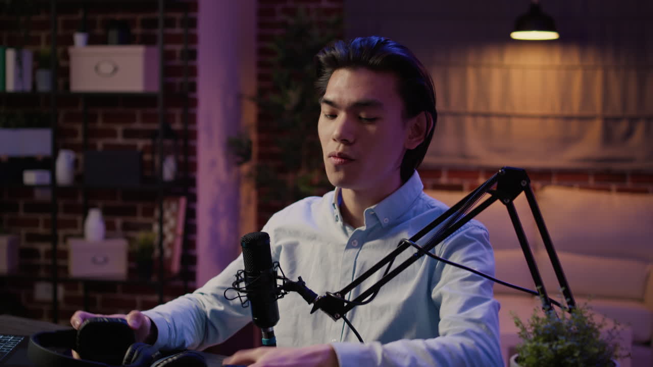 Young man recording a podcast with headphones