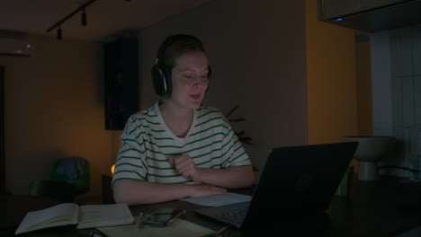adolescente estudiando en línea por la noche