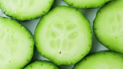 top view of fresh sliced cucumber rotation. 4k macro