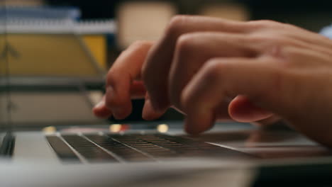 Closeup-hands-typing-laptop-at-evening-home.-Freelancer-using-computer-alone