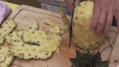 Outdoor-summer-party-slicing-pineapple-up