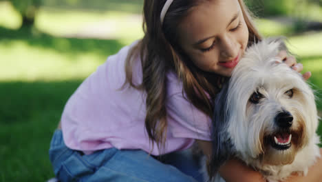 girl playing with her dog in the park