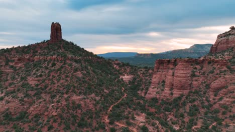 flying towards red rock butte formations with lush vegetations at sedona in central arizona