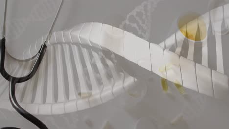 animation of dna strands over pills and stethoscope