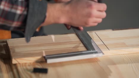 large plancho male hands drawing a line of a square ruler