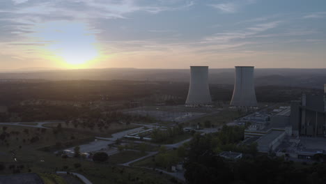 thermoelectric power plant chimneys shot by drone at sunset