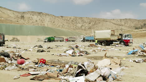 garbage trucks operating at a large landfill site