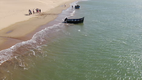 aerial shot of people getting off the boat, nayla lagoon in tarfaya, morocco