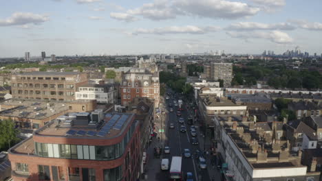 low aerial tracks traffic on picturesque holloway rd in london, gbr