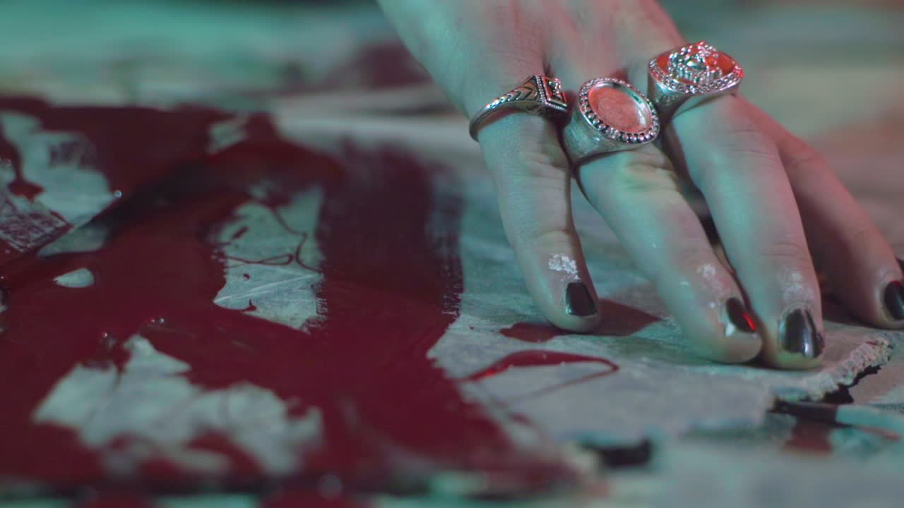 Female Hand Touching Surface With Blood. close up
