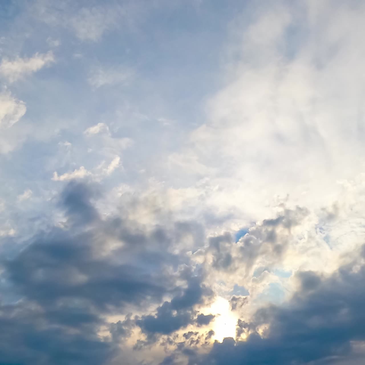 Amazing light clouds appearing in the sky. Timelapse of quick cloud transformation. Low angle view