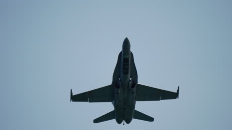 military jet in midair banking maneuver with visible motion blur indicating high speed