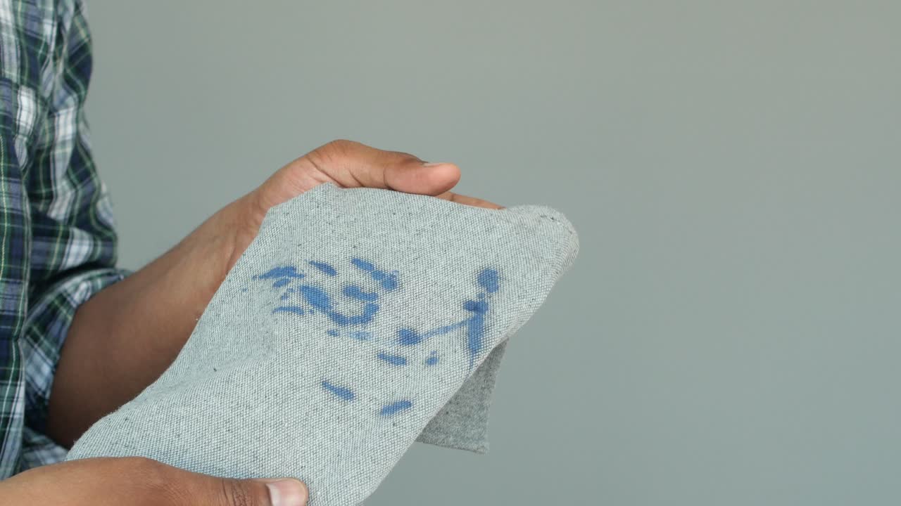 Man Holding a Stained Piece of Cloth