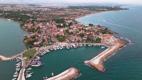 boats in harbor of old town in side, turkey by apollo temple, aerial