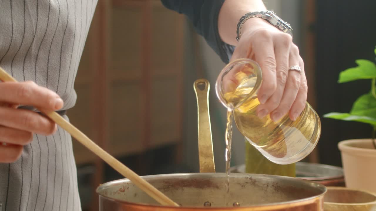 Crop woman preparing risotto in kitchen