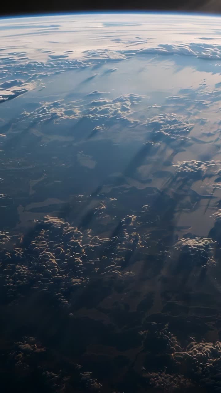 Vertical video: Sun nearing horizon, camera drifting over Earth's curve revealing city lights