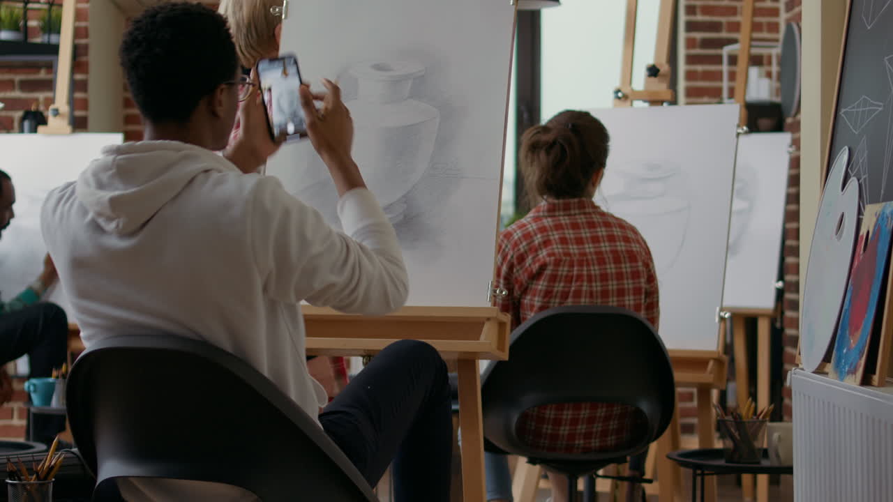 Artistic person taking photo of vase masterpiece on canvas