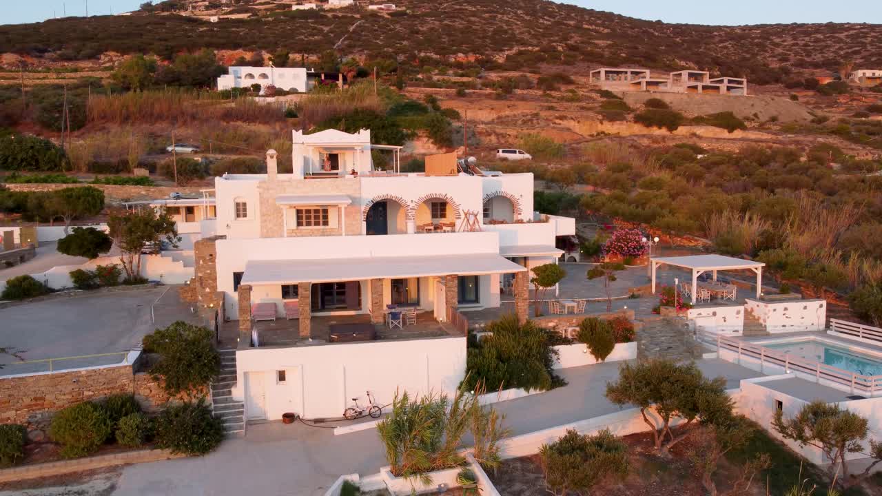 Aerial Orbit of Typical Greek Luxurious Hotel at sunset, Paros