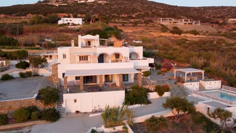aerial orbit of typical greek luxurious hotel at sunset, paros
