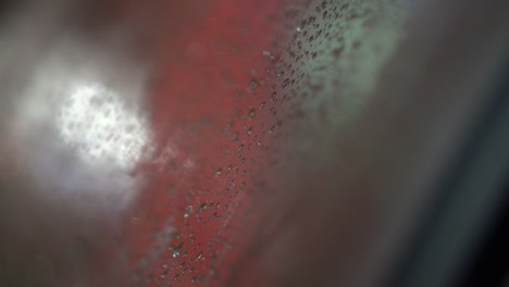 rain soaked window in tram car