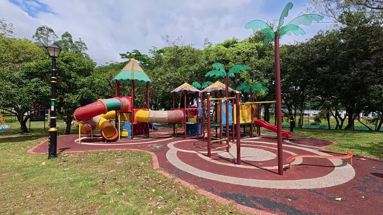 A vibrant public playground for children in a beautiful tropical park. Sunny weather enhances the cheerful outdoor atmosphere