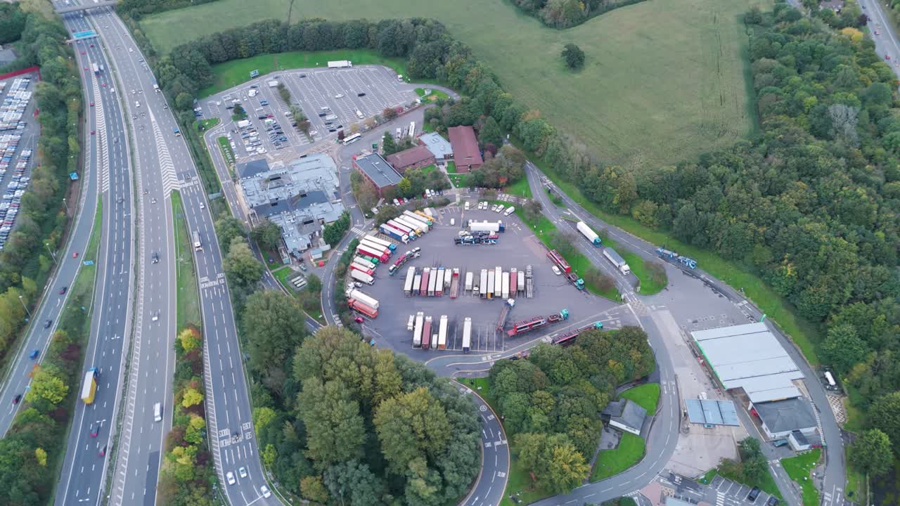 Aerial flyover of Gordano motorway services, showcasing amenities and parking surrounded by countryside, outside Bristol UK, October 2024