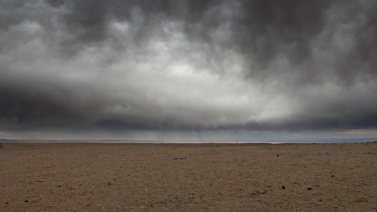 Dark Storm Clouds Gathering Over a Vast Desert Landscape