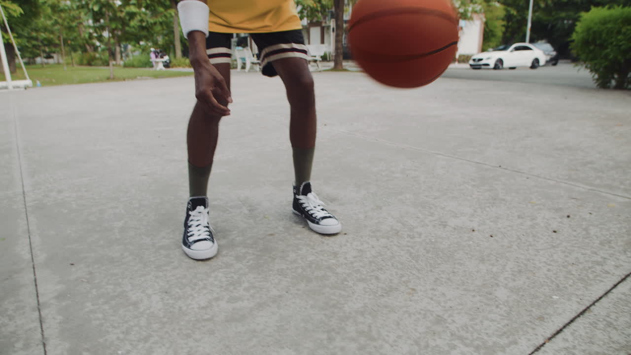 Slowmo of Black Sportsman Bouncing and Throwing Ball in Ring