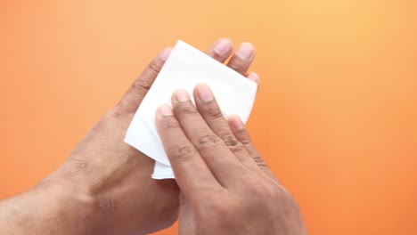 hands being cleaned with tissue