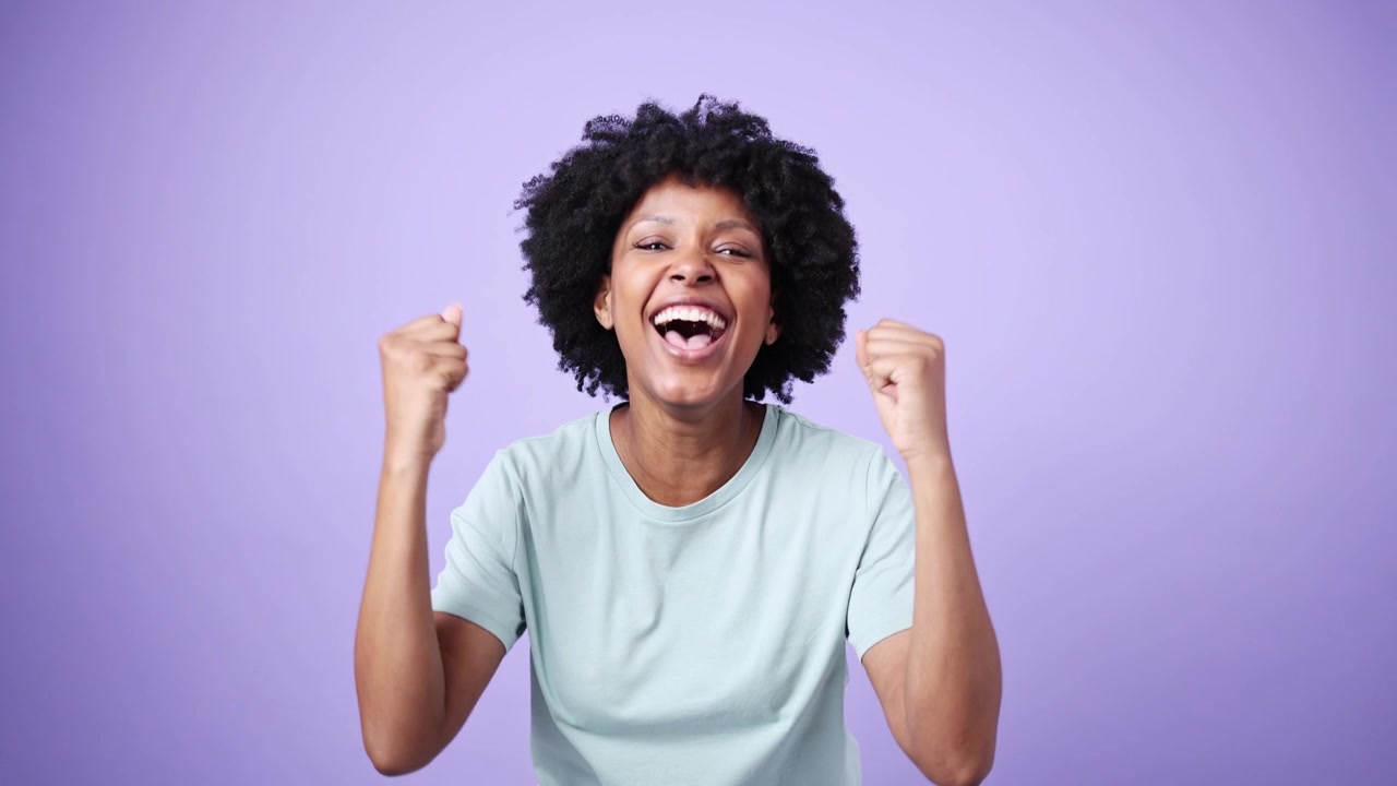 Young African American Woman Reacting with Surprise and Joy