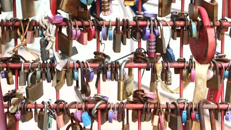 Many-love-padlocks-locked-on-rusty-iron-gate-in-singapore-,