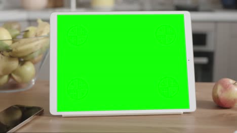 tablet on wooden table in kitchen interior