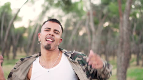 young man in camouflage jacket expressing himself in a forest