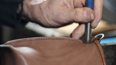 artisan hand riveting leather bag leatherwork