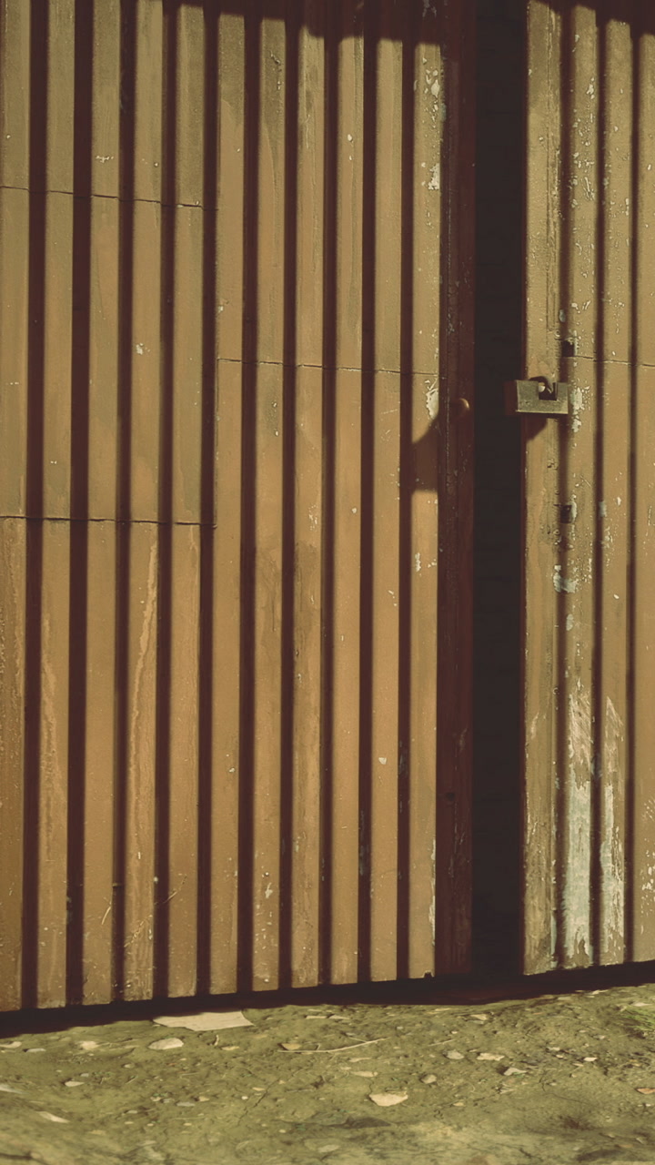 Wooden gate with shadows at sunset in an outdoor setting