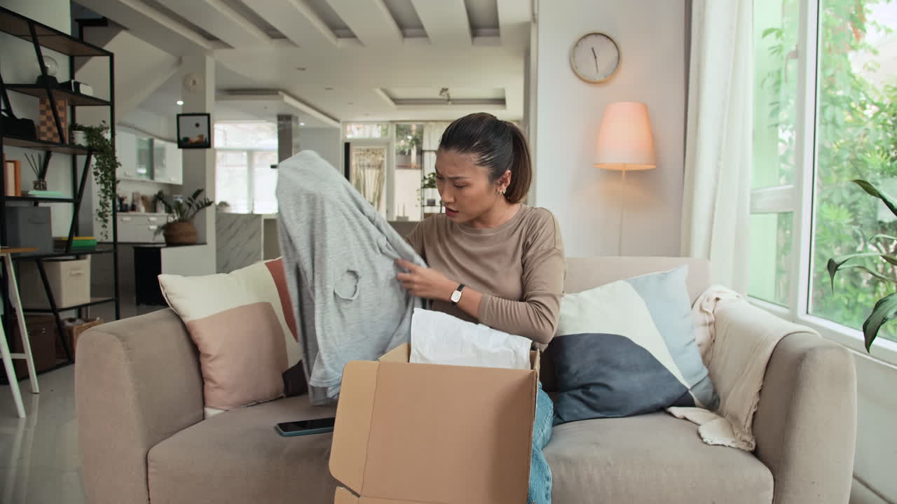 Female Client Opening Parcel with Defective Long Sleeve at Home