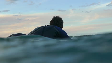 surfer paddling out slow motion sunset smooth really nice water housing intimate going up jetty to surf cinematic by taylor brant film