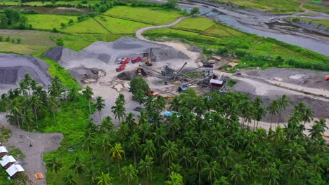 Aerial-View-Of-Machinery-And-Crushers-Working-At-Gravel-Pit-Quarry-Near-Green-FIelds-And-River