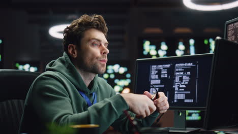 Overworked programer looking monitor working late in office closeup. Man typing