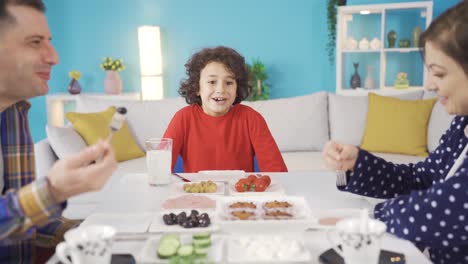 happy smiling cheerful family enjoying spending time together while having breakfast at home in the morning.