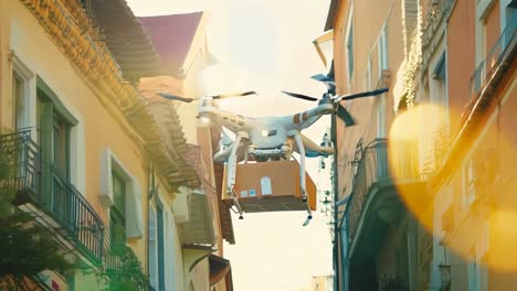 a drone flying over a city street with a box in the air