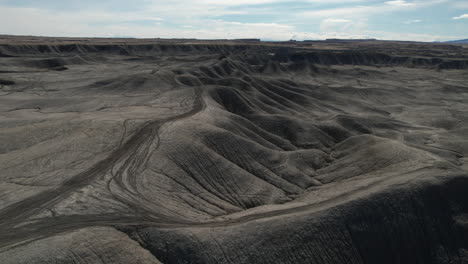 drone shot of moonlike landscape, dry gray barren hills and vastness, revealing drone shot