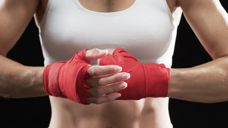 young caucasian woman boxer ready for a boxing workout on a black background