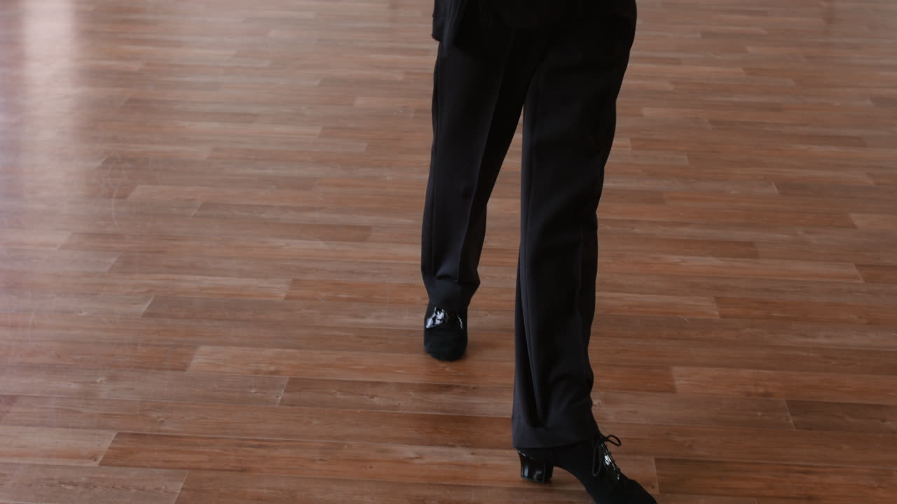 Dancer's Legs and Feet Moving on a Wooden Floor