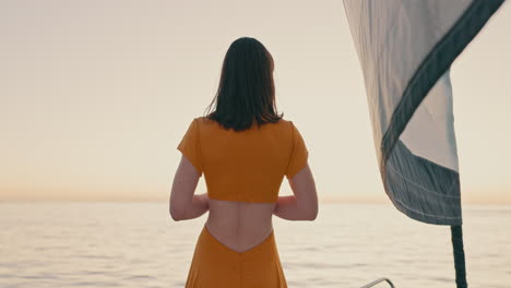 back, sunset and horizon with a woman on a yacht