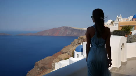 woman enjoying the scenic view of santorini, greece